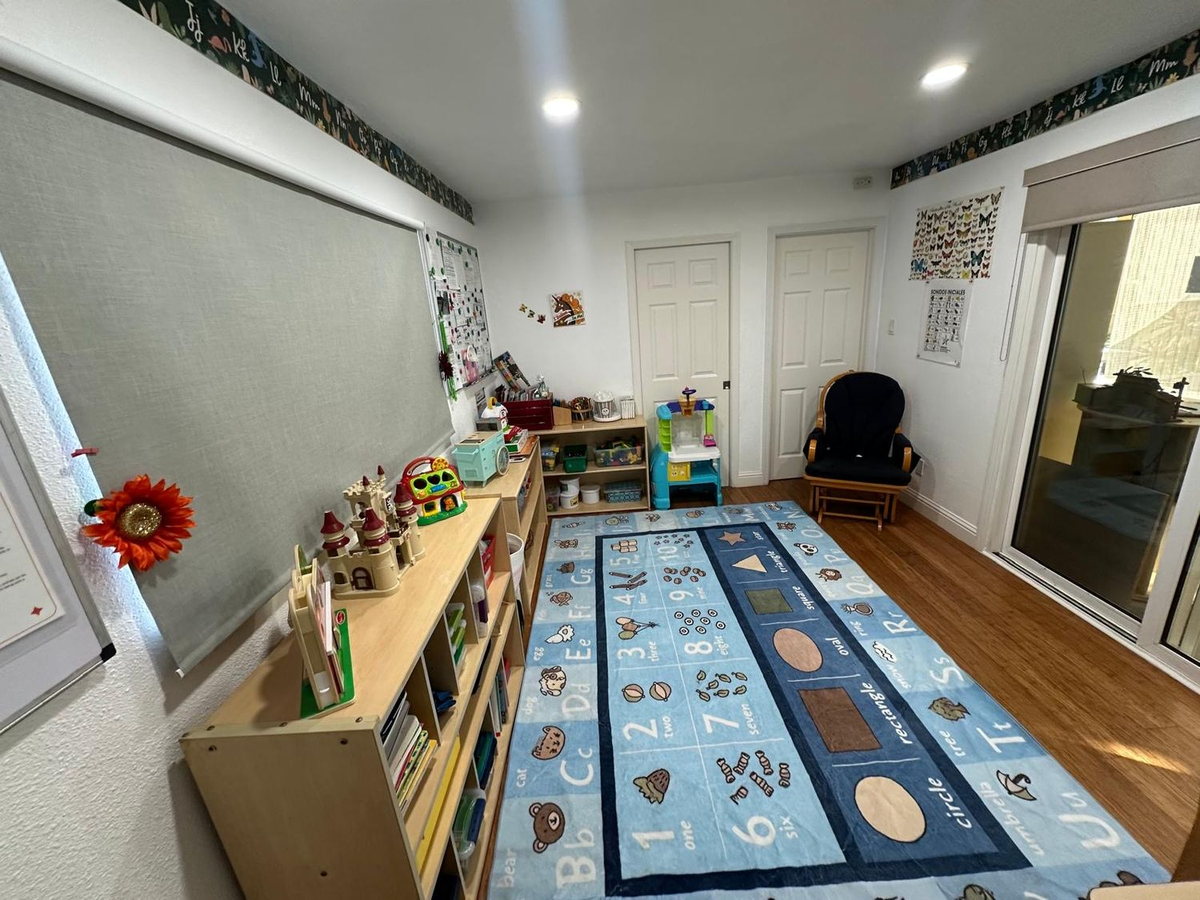 Bright indoor play and learning space with alphabet rug
